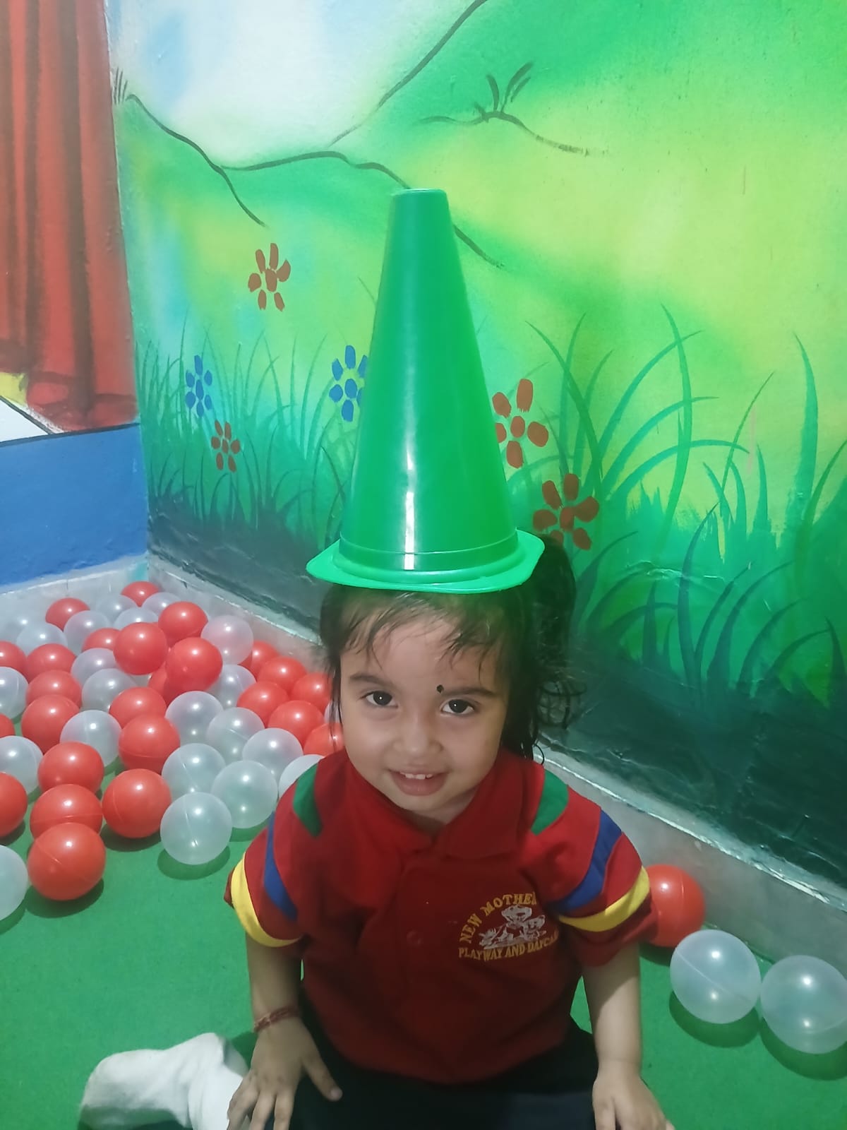 A smiling child enjoying playtime at New Mother's Care