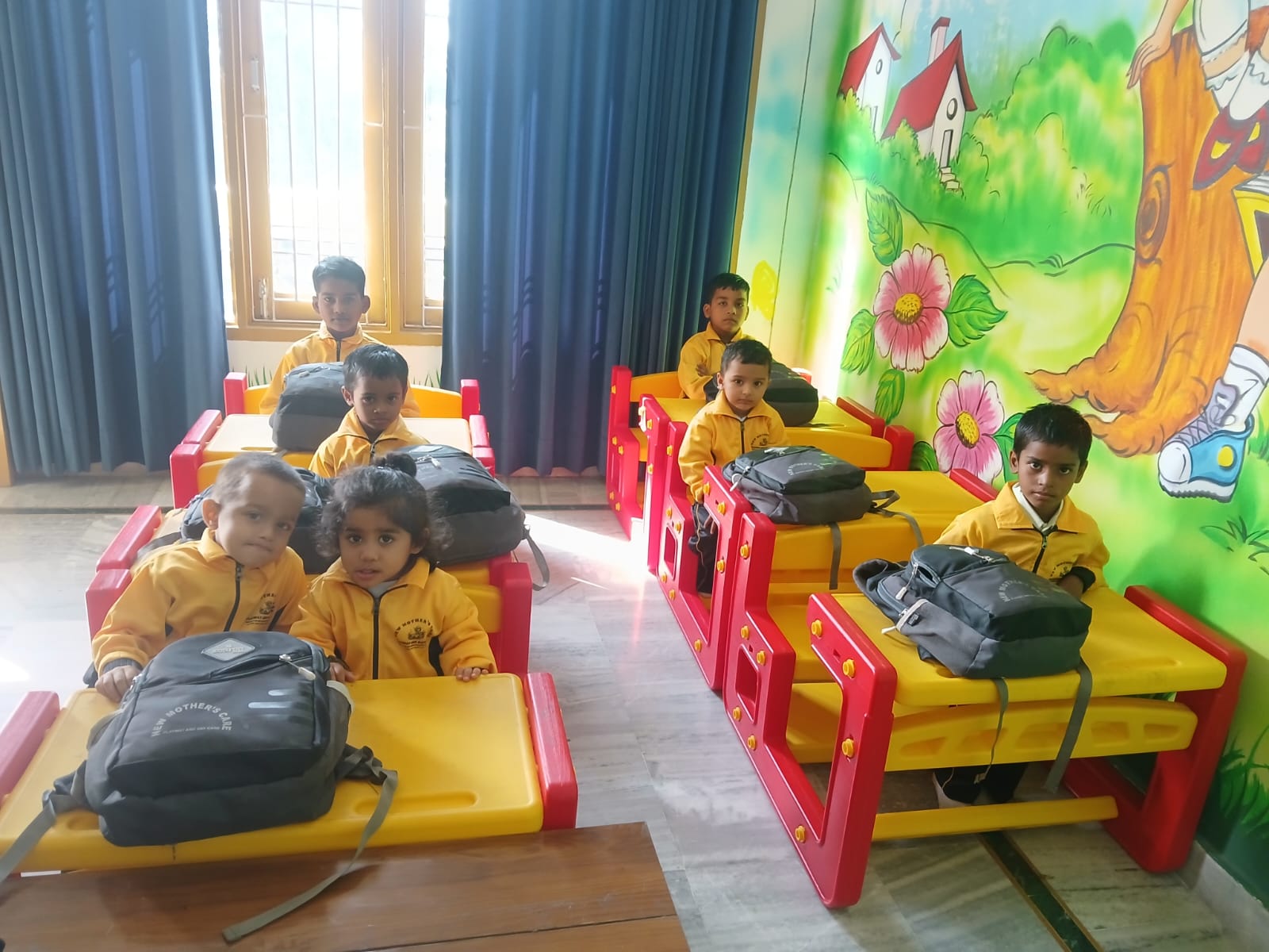 Children seated at their classroom desks at New Mother's Care Playway and Daycare