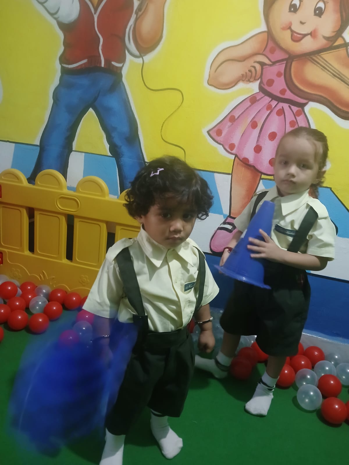 Nursery children playing together in the ball pit